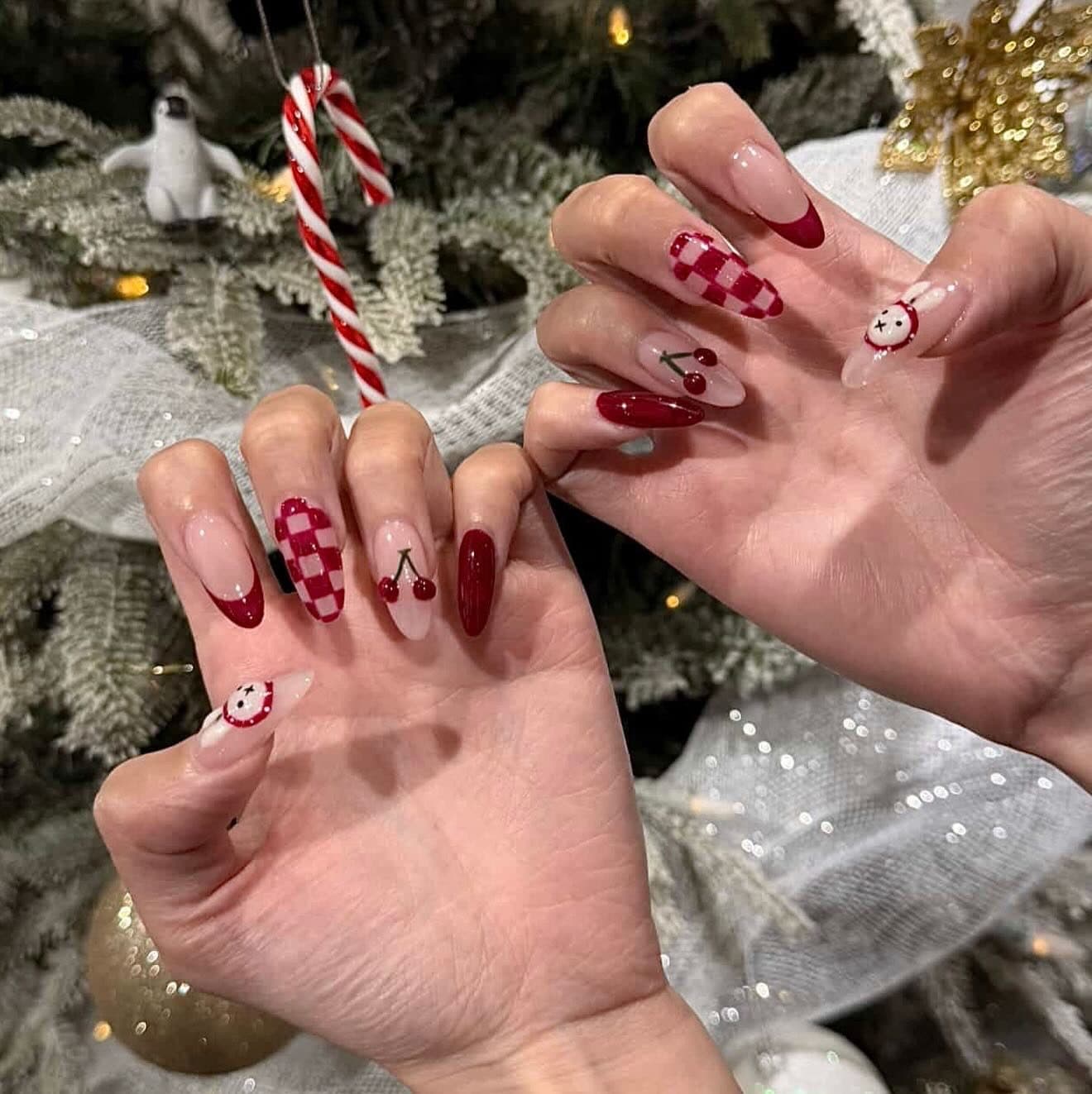 Holiday red cherry and checkerboard nail art