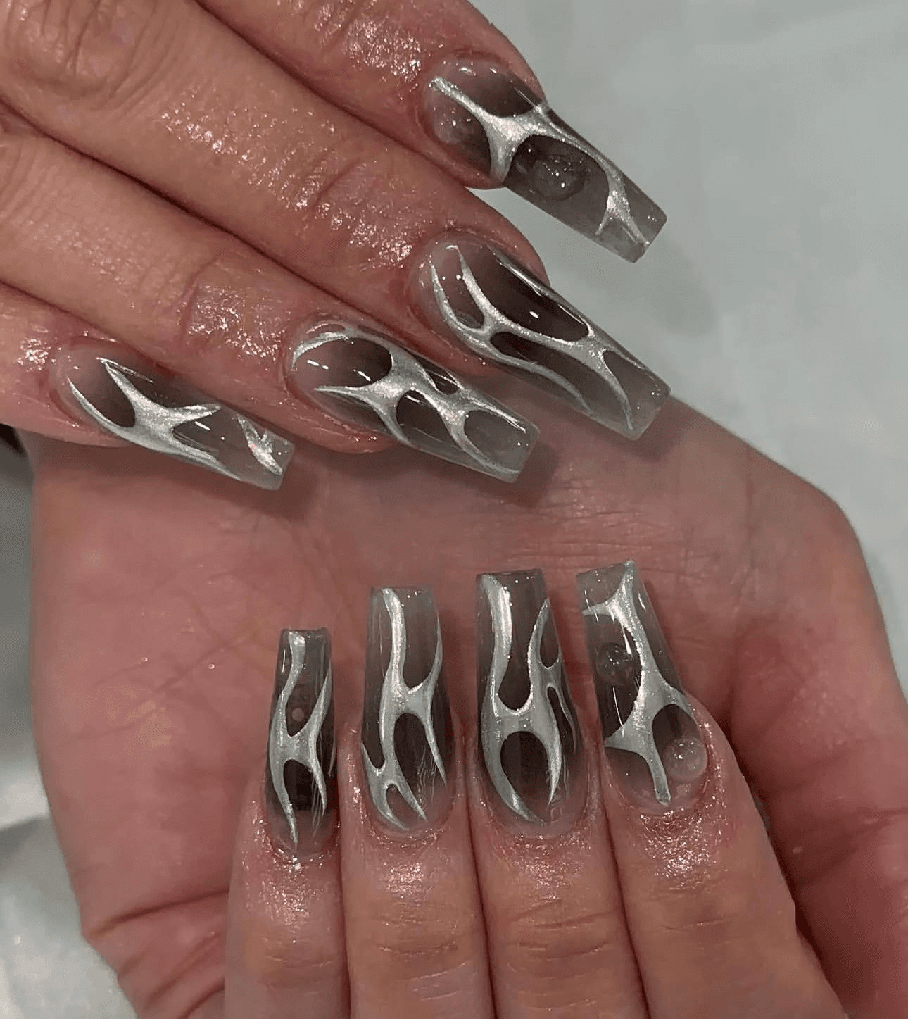 Chrome sculpted nail art with clear details
