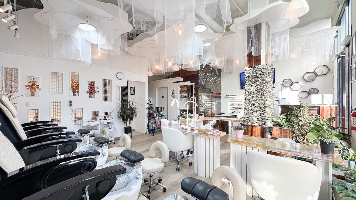 Nail stations and pedicure chairs at JOVIAL BEAUTY
